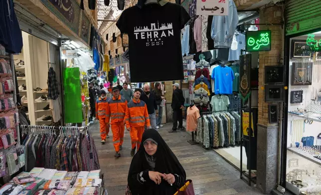 Pedestrians walk through Tajrish Bazaar in Tehran, Iran, Tuesday, April 7, 2026. (AP Photo/Francisco Seco)
