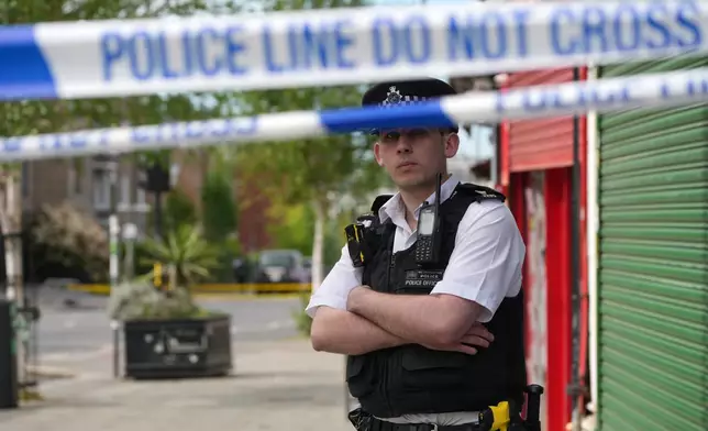 A police officer stands behind a police cordon after two people were stabbed in Golders Green neighbourhood, that has a large Jewish community, in London, Wednesday, April 29, 2026.(AP Photo/Kin Cheung)