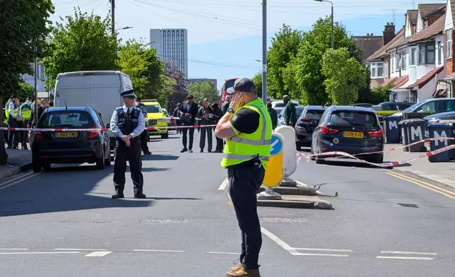 Police officers at the scene in Golders Green after two people were stabbed, in north-west London, Wednesday April 29, 2026. (Jamie Lashmar/PA via AP)