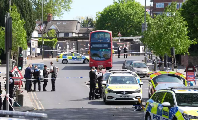 Police at the scene where two people were stabbed Wednesday April 29, 2026 in a London neighborhood with a large Jewish community and a 45-year-old man was arrested on suspicion of attempted murder over what authorities called an antisemitic attack. (Lucy North/PA via AP)