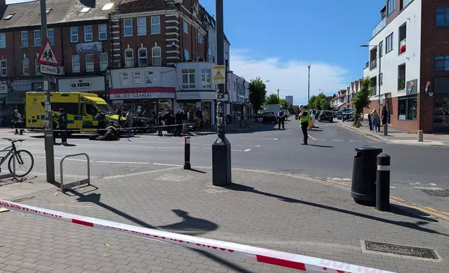 Police officers at the scene in Golders Green after two people were stabbed, in north-west London, Wednesday April 29, 2026. (Jamie Lashmar/PA via AP)