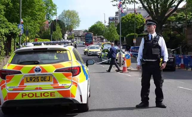 A police officer at the scene where two people were stabbed Wednesday April 29, 2026 in a London neighborhood with a large Jewish community and a 45-year-old man was arrested on suspicion of attempted murder over what authorities called an antisemitic attack. (Lucy North/PA via AP)