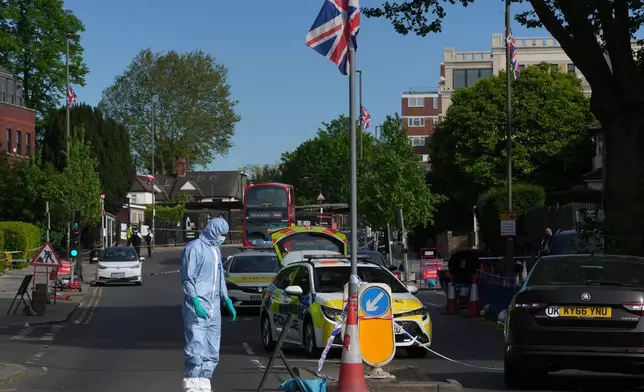 Forensic officers search the area after two people were stabbed in Golders Green neighborhood, that has a large Jewish community, in London, Wednesday, April 29, 2026.(AP Photo/Kin Cheung)