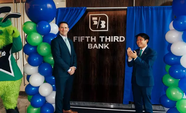 Brian Enzler, Fifth Third North Texas Region President and Gabriel Wang, Fifth Third Financial Center Manager, reveal the new Fifth Third signage at Cowboys Way.