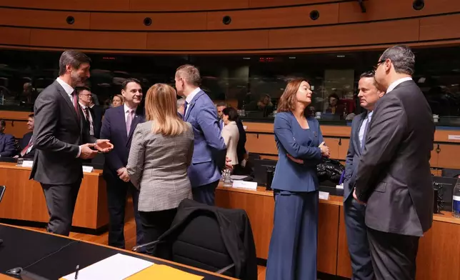 Slovenia's Foreign Minister Tanja Fajon, third right, speaks with Cypriot Foreign Minister Constantinos Kombos, right, and Luxembourg's Foreign Minister Xavier Bettel, second right, during a meeting of EU foreign ministers at the European Council building in Luxembourg, Tuesday, April 21, 2026. (AP Photo/Virginia Mayo)