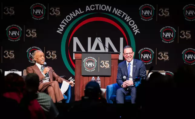 Josh Shapiro, Governor of Pennsylvania, speaks with Reverend Al Sharpton during the National Action Network (NAN) Convention in New York, Wednesday, April 8, 2026. (AP Photo/Angelina Katsanis)