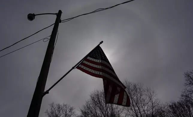 A U.S. flag decorates an electric pole outside Ashley Nicole Dixon's home in Danese, W.Va., Saturday, March 21, 2026. (AP Photo/Carolyn Kaster)