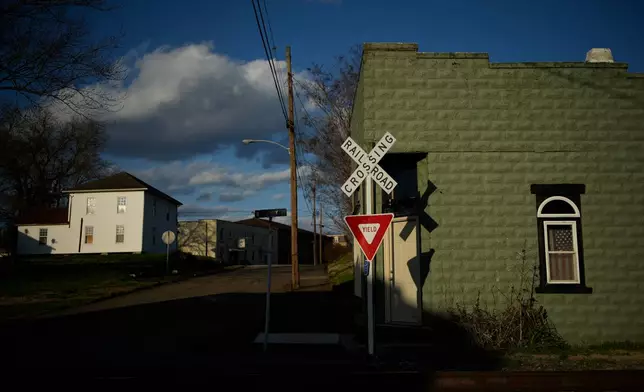 A railroad crossing is seen in the evening light, Thursday, March 12, 2026, in Ravenswood, W.Va., where some shop owners were forced to shut down during winter because they couldn't pay their electric bills. (AP Photo/Carolyn Kaster)