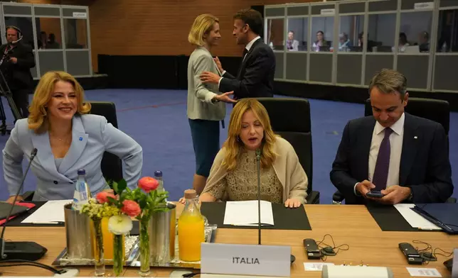 European Union foreign policy chief Kaja Kallas, background left, speaks with French President Emmanuel Macron, as Latvia's Prime Minister Evika Silina, foreground left, Italy's Prime Minister Giorgia Meloni, center, and Greece's Prime Minister Kyriakos Mitsotakis prepare for a roundtable meeting pf the EU Summit in Nicosia, Cyprus, Friday, April 24, 2026. (AP Photo/Petros Karadjias)
