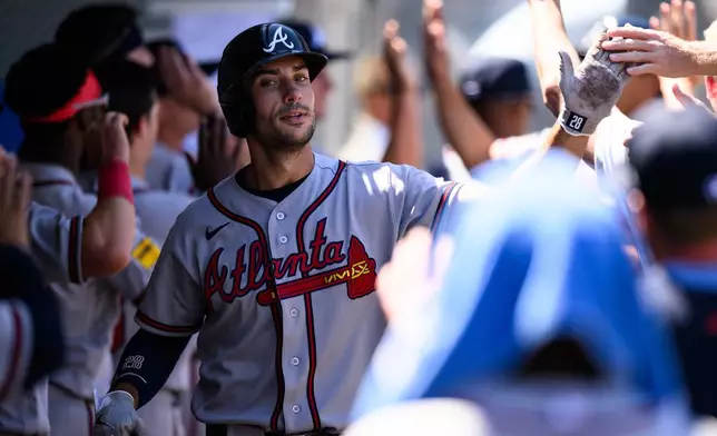 Atlanta Braves first baseman Matt Olson is greeted by teammates after scoring during the third inning of a baseball game against the Los Angeles Angels, Wednesday, April 8, 2026, in Anaheim, Calif. (AP Photo/William Liang)