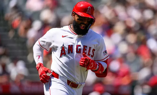 Los Angeles Angels designated hitter Jo Adell reacts after hitting a single during the second inning of a baseball game against the Atlanta Braves, Wednesday, April 8, 2026, in Anaheim, Calif. (AP Photo/William Liang)