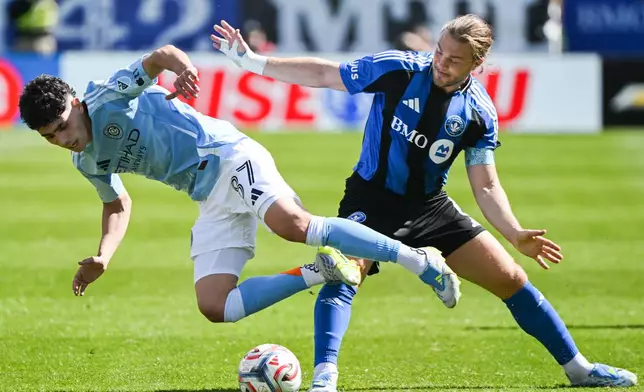 New York City FC's Arnau Farnos (87) is knocked off the ball by CF Montreal's Samuel Piette (6) during the first half of a MLS soccer game in Montreal, Saturday, April 25, 2026.(Graham Hughes/The Canadian Press via AP)