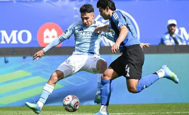 CF Montreal's Brayan Vera (4) challenges for ball with New York City's Agustin Ojeda (26) during the first half of a MLS soccer game in Montreal, Saturday, April 25, 2026.(Graham Hughes/The Canadian Press via AP)