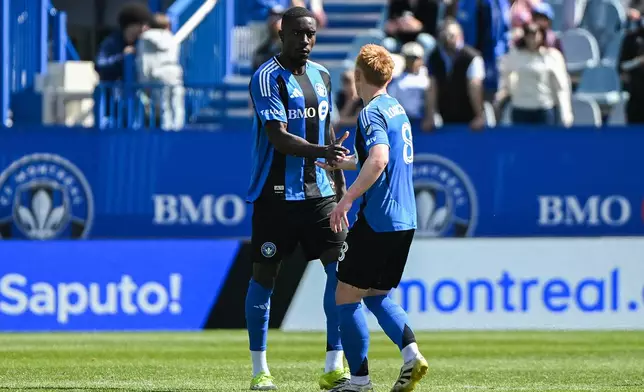 CF Montreal's Prince Owusu, left, celebrates with teammate Matty Longstaff (8) after scoring against New York City FC during the first half of a MLS soccer game in Montreal, Saturday, April 25, 2026.(Graham Hughes/The Canadian Press via AP)