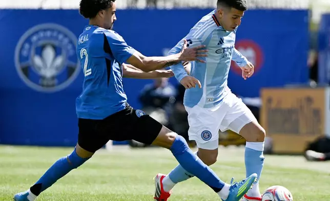 CF Montreal's Jalen Neal (2) battles for the ball with New York City's Nicolas Fernandez (7) during the first half of a MLS soccer game in Montreal, Saturday, April 25, 2026.(Graham Hughes/The Canadian Press via AP)