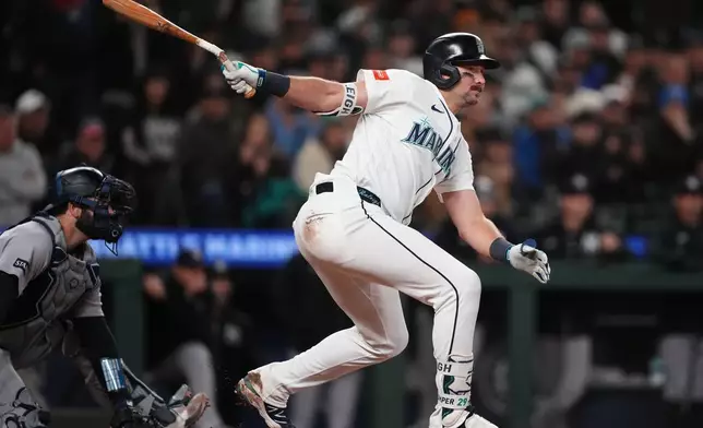 Seattle Mariners' Cal Raleigh follows through on a two-run single against the New York Yankees during the eighth inning of a baseball game, Wednesday, April 1, 2026, in Seattle. (AP Photo/Lindsey Wasson)