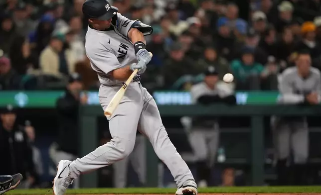 New York Yankees' Paul Goldschmidt hits a three-run home run against the Seattle Mariners during the sixth inning of a baseball game, Wednesday, April 1, 2026, in Seattle. (AP Photo/Lindsey Wasson)