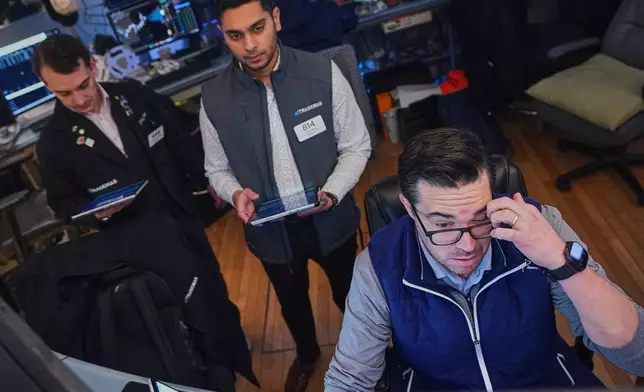 Joseph Lawler, right, works with fellow traders on the floor of the New York Stock Exchange, Thursday, April 23, 2026. (AP Photo/Richard Drew)