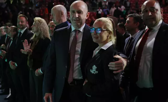 Former Bulgarian President Rumen Radev, center, poses with a supporter at the closing rally of his campaign, in Sofia, Thursday, April 16, 2026, as Bulgaria heads into an early parliamentary election. (AP Photo/Valentina Petrova)