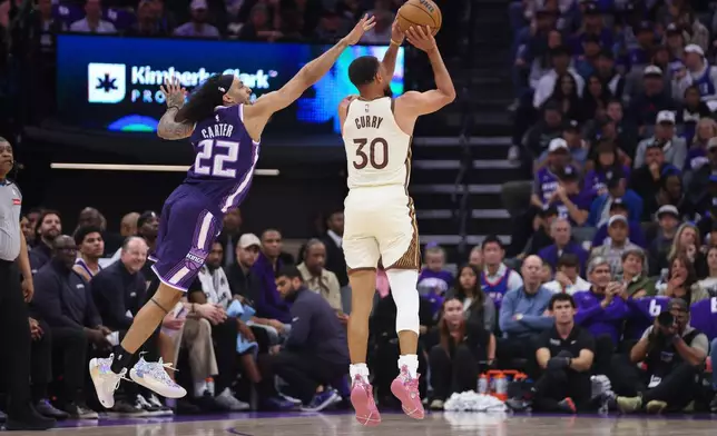 Golden State Warriors guard Stephen Curry (30) attempts a three point basket during the first half of an NBA basketball game against the Sacramento Kings Friday, April 10, 2026, in Sacramento, Calif. (AP Photo/Scott Marshall)