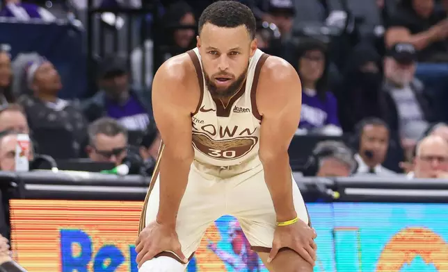 Golden State Warriors guard Stephen Curry looks on during the first half of an NBA basketball game against the Sacramento Kings, Friday, April 10, 2026, in Sacramento, Calif. (AP Photo/Scott Marshall)