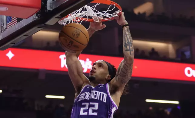 Sacramento Kings guard Devin Carter dunks the ball during the first half of an NBA basketball game against the Golden State Warriors, Friday, April 10, 2026, in Sacramento, Calif. (AP Photo/Scott Marshall)