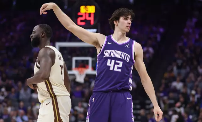 Sacramento Kings center Maxime Raynaud (42) looks into the crowd after making a 3-point basket during the first half of an NBA basketball game against the Golden State Warriors, Friday, April 10, 2026, in Sacramento, Calif. (AP Photo/Scott Marshall)