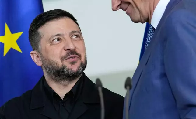 Ukraine's President Volodymyr Zelenskyy and German Chancellor Friedrich Merz attend a press conference at the German-Ukrainian government consultations in Berlin Germany, Tuesday, April 14, 2026. (AP Photo/Ebrahim Noroozi)