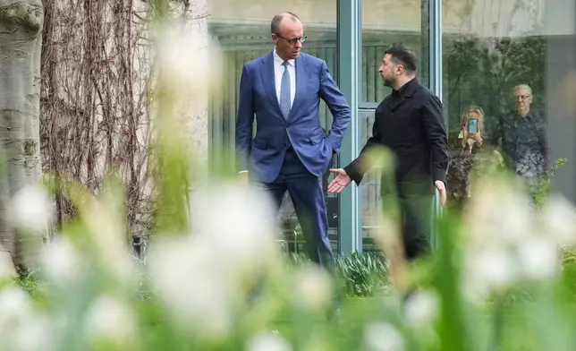 German chancellor Friedrich Merz welcomes Ukraine's President Volodymyr Zelenskyy for German-Ukrainian government consultations in Berlin Germany, Tuesday, April 14, 2026. (AP Photo/Markus Schreiber)