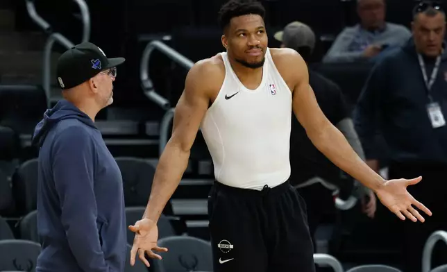 Milwaukee Bucks forward Giannis Antetokounmpo, right, talks to the Dallas Mavericks head coach Jason Kidd before an NBA basketball game Tuesday, March 31, 2026, in Milwaukee. (AP Photo/Jeffrey Phelps)