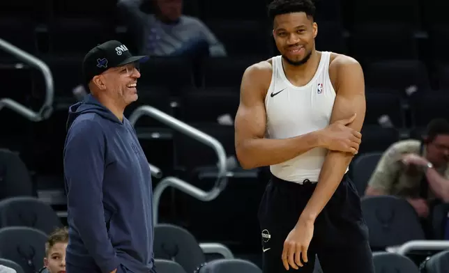 Milwaukee Bucks forward Giannis Antetokounmpo, right, talks to the Dallas Mavericks head coach Jason Kidd before an NBA basketball game Tuesday, March 31, 2026, in Milwaukee. (AP Photo/Jeffrey Phelps)