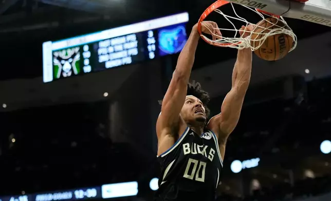 Milwaukee Bucks' Jericho Sims dunks during the first half of an NBA basketball game against the Memphis Grizzlies, Sunday, April 5, 2026, in Milwaukee. (AP Photo/Aaron Gash)
