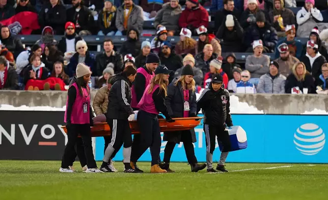 Japan defender Hikaru Kitagawa is taken off the pitch by trainers after sustaining an injury during the first half of an international friendly soccer match against the United States, Friday, April 17, 2026, in Commerce City, Colo. (AP Photo/Jack Dempsey)