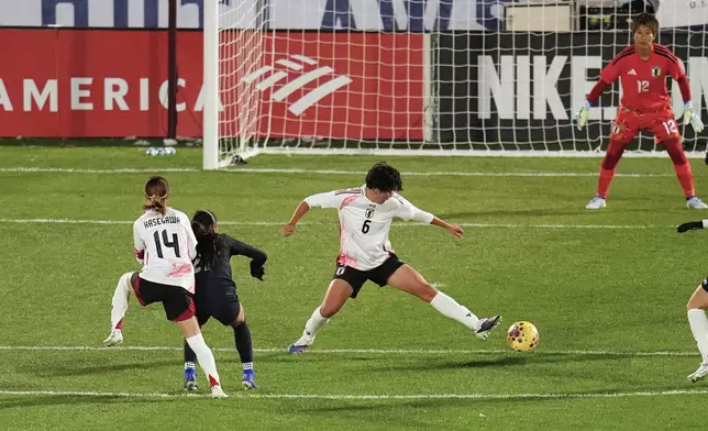 Japan defender Toko Koga (6) tries to block a shot by United States defender Gisele Thompson during the first half of an international friendly soccer match Friday, April 17, 2026, in Commerce City, Colo. (AP Photo/Jack Dempsey)