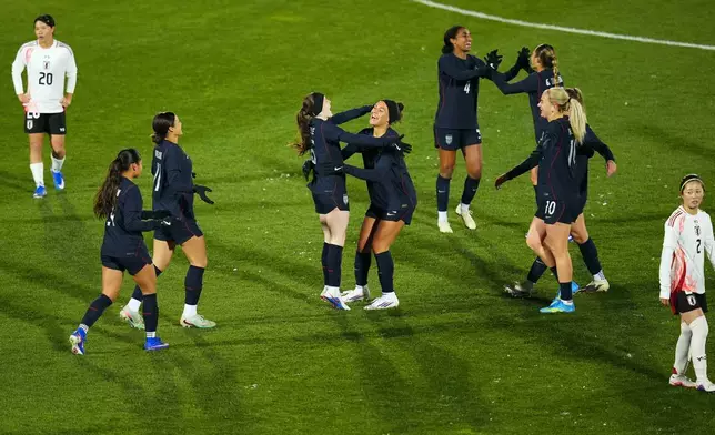 United States midfielder Rose Lavelle, center left, celebrates after a goal with teammate Trinity Rodman, center right, during the second half of an international friendly soccer match against Japan Friday, April 17, 2026, in Commerce City, Colo. (AP Photo/Jack Dempsey)