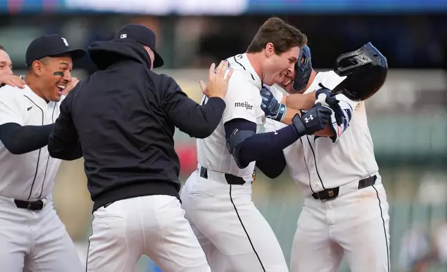 Detroit Tigers second baseman Colt Keith, right, celebrates his one-run single against the Kansas City Royals during the ninth inning of a baseball game Thursday, April 16, 2026, in Detroit. (AP Photo/Paul Sancya)