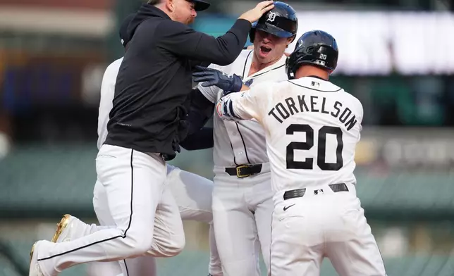Detroit Tigers' Colt Keith, center, celebrates his one-run single with Jake Rogers, left, andSpencer Torkelson (20) against the Kansas City Royals during the ninth inning of a baseball game Thursday, April 16, 2026, in Detroit. (AP Photo/Paul Sancya)