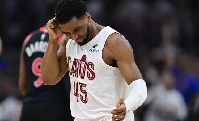 Cleveland Cavaliers guard Donovan Mitchell reacts after making a three point basket during the first half in Game 5 of a first-round NBA playoffs basketball series against the Toronto Raptors, Wednesday, April 29, 2026, In Cleveland. (AP Photo/David Dermer)
