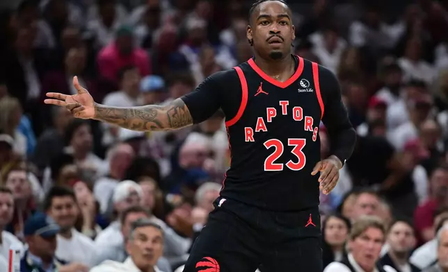 Toronto Raptors guard Jamal Shead reacts after making a three point basket during the first half in Game 5 of a first-round NBA playoffs basketball series against the Cleveland Cavaliers, Wednesday, April 29, 2026, In Cleveland. (AP Photo/David Dermer)