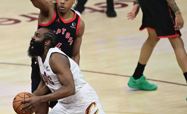 Cleveland Cavaliers guard James Harden goes to the basket against Toronto Raptors forward Scottie Barnes during the first half in Game 5 of a first-round NBA playoffs basketball series, Wednesday, April 29, 2026, In Cleveland. (AP Photo/David Dermer)