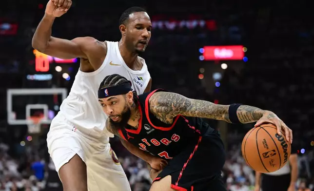 Toronto Raptors forward Brandon Ingram drives on Cleveland Cavaliers center Evan Mobley during the first half in Game 5 of a first-round NBA playoffs basketball series, Wednesday, April 29, 2026, In Cleveland. (AP Photo/David Dermer)