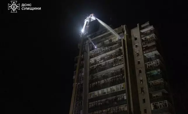 In this photo provided by the Ukrainian Emergency Services on Saturday, April 4, 2026, rescue workers put out a fire of a residential building damaged following a Russian strike in Sumy, Ukraine. (Ukrainian Emergency Service via AP)