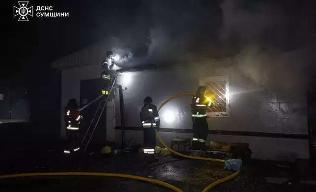 In this photo provided by the Ukrainian Emergency Services on Saturday, April 4, 2026, rescue workers put out a fire of a residential building damaged following a Russian strike in Sumy, Ukraine. (Ukrainian Emergency Service via AP)