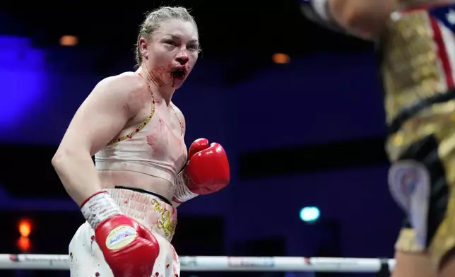 Boxer Lauren Price is bloodied during a welterweight title bout agasinst Stephanie Pineiro in Cardiff, Wales, Saturday April 4, 2026.(Nick Potts/PA via AP)