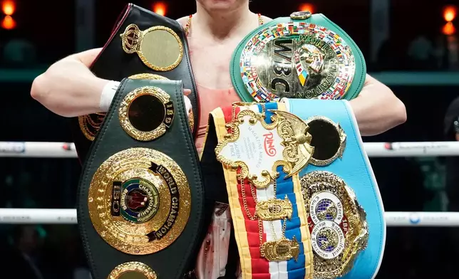 Boxer Lauren Price poses with her belts after winning a welterweight title bout against Stephanie Pineiro in Cardiff, Wales, Saturday April 4, 2026.(Nick Potts/PA via AP)
