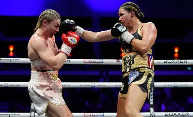 Boxer Stephanie Pineiro, right, punches Lauren Price during their welterweight title bout in Cardiff, Wales, Saturday April 4, 2026.(Nick Potts/PA via AP)