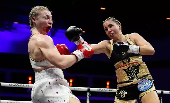Stephanie Pineiro, right, punches Lauren Price during their welterweight title bout in Cardiff, Wales, Saturday April 4, 2026.(Nick Potts/PA via AP)