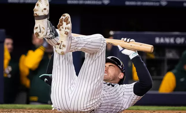 New York Yankees left fielder Cody Bellinger (35) drops to the ground after striking during the fifth inning of a baseball game against the Athletics, Tuesday, April 7, 2026, in New York. (AP Photo/Angelina Katsanis)