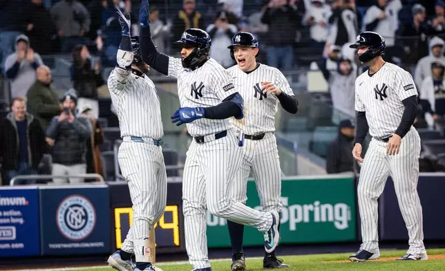 New York Yankees third baseman Amed Rosario (14) scores a three-run home run during the eighth inning of a baseball game against the Athletics, Tuesday, April 7, 2026, in New York. (AP Photo/Angelina Katsanis)