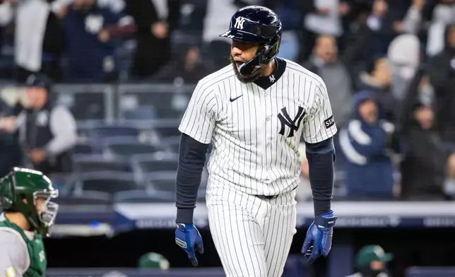 New York Yankees third baseman Amed Rosario (14) scores a three-run home run during the eighth inning of a baseball game against the Athletics, Tuesday, April 7, 2026, in New York. (AP Photo/Angelina Katsanis)